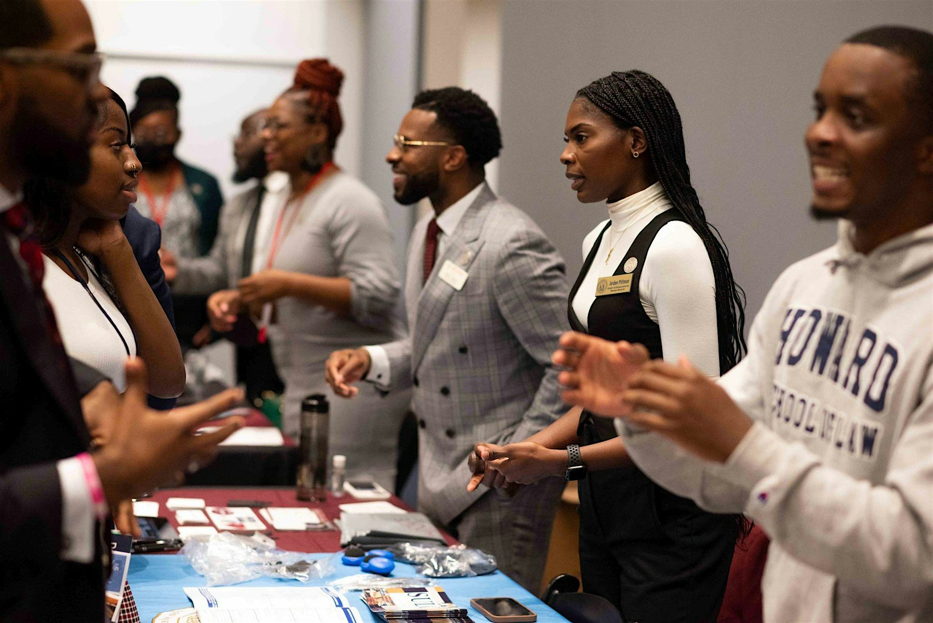 Law school recruiters shaking hands with HBCU students at the Law Expo